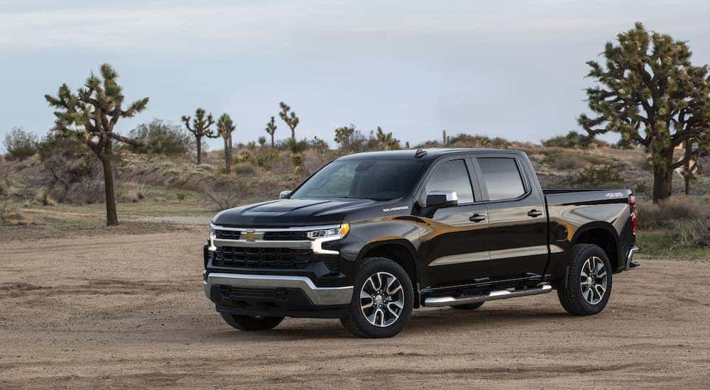 A black 2022 Chevy Silverado 1500 LT is shown from the front at an angle.