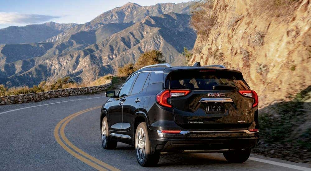 A red 2023 GMC Terrain Denali is shown from the rear at an angle.