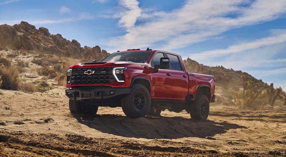 A red 2024 Chevy Silverado 2500 HD ZR2 Bison is shown from the front at an angle.