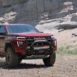 A red 2023 GMC Canyon AT4x is shown from the front at an angle.