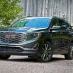 A grey 2020 GMC Terrain Denali is shown near a barn after leaving a Columbia GMC dealer.