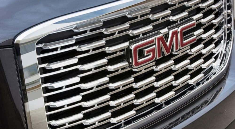 A close up shows the chrome grille on a grey 2020 GMC Yukon XL Denali.