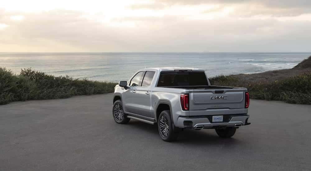 A silver 2022 GMC Sierra 1500 Denali Ultimate is shown from the rear at an angle.
