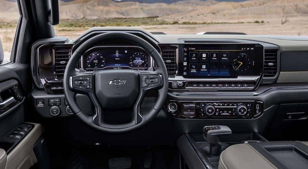 The black interior of a 2024 Chevy Silverado 1500 ZR2 is shown from the driver's seat.
