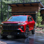 A red 2024 Chevy Traverse is shown parked in a driveway after visiting a Chevy dealer near Lynchburg.