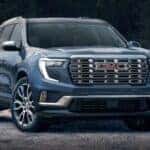 A blue 2024 GMC Acadia is shown parked after visiting a GMC dealer near Lynchburg.
