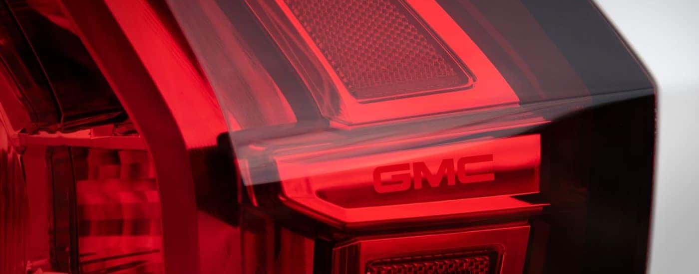 A close up shows taillights details op a white 2021 GMC Yukon AT4.