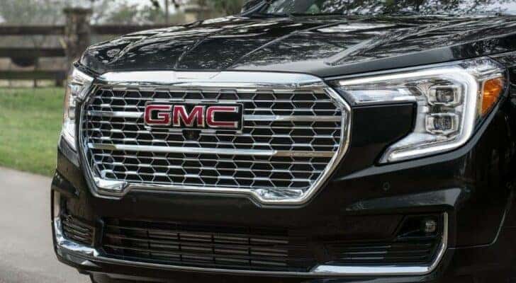 A close up shows the chrome grille on a black 2024 GMC Terrain Denali.