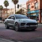 2019 Porsche Macan driving through a city intersection