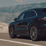 Porsche Cayenne cruising down highway in the desert