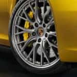 Close up of passenger side wheels on yellow Porsche 911