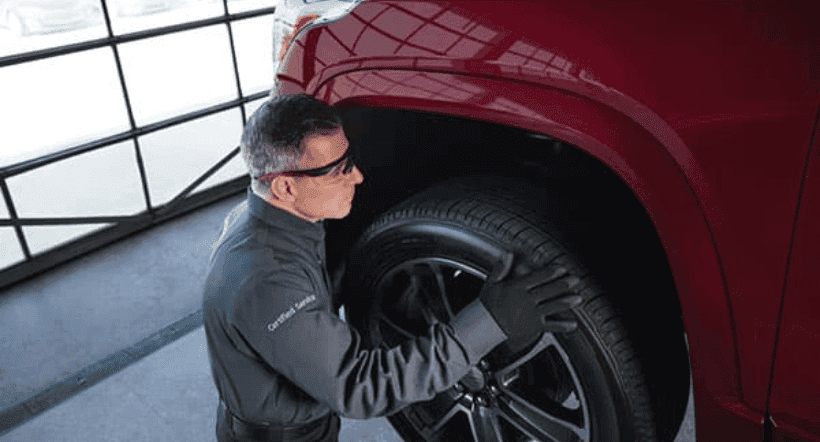 Technician checking tire