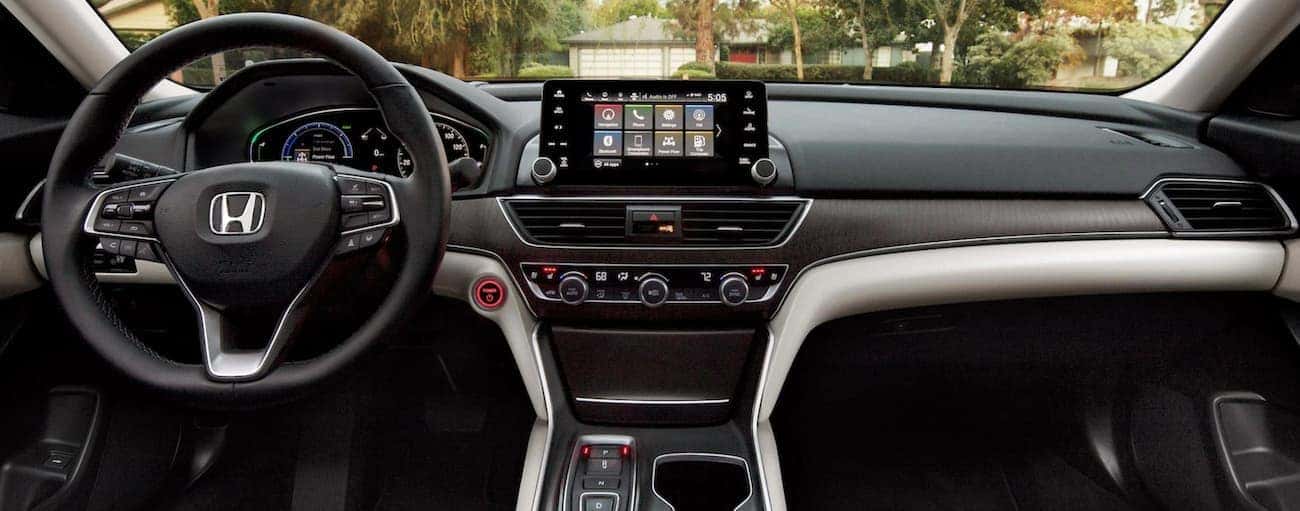 The dashboard and infotainment screen in a 2021 Honda Accord Hybrid Touring are shown.