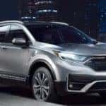 A silver 2021 Honda CR-V Touring is parked on the side of a city street after leaving Rochester Honda CR-V dealership.