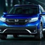 A blue 2022 Honda CR-V is shown from the front driving through a tunnel.