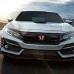A white 2020 Honda Civic Type R is shown from the front while it drives down the road after leaving one of the Honda dealers in Rochester.