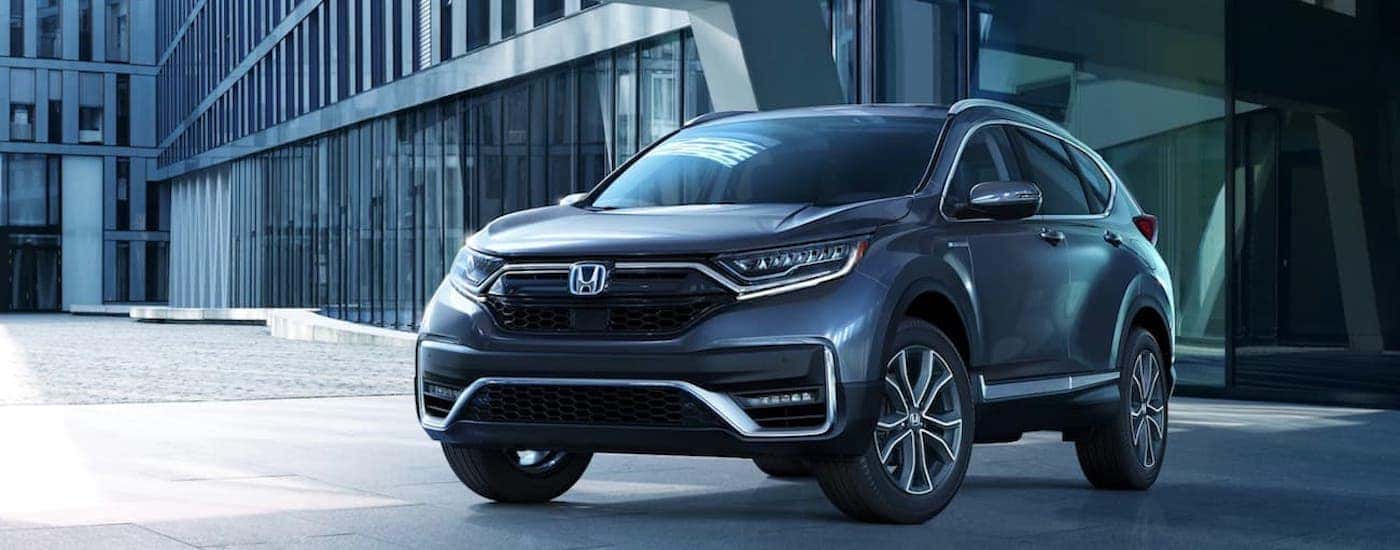 A grey 2021 Honda CR-V Hybrid Touring is shown parked in a garage after leaving a Le Roy Honda CR-V dealer.