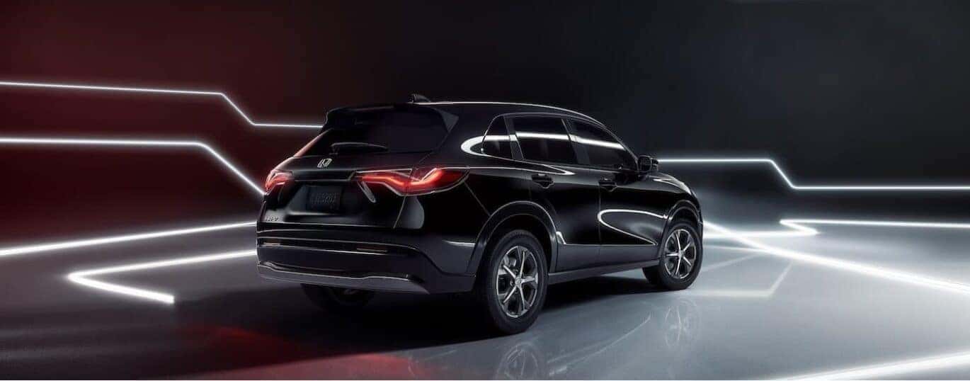 A black 2025 Honda HR-V is shown parked on a showroom floor.