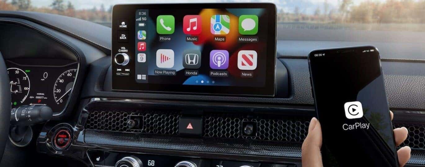 A close-up of the infotainment screen is shown in a 2025 Honda CR-V Sport Touring Hybrid.