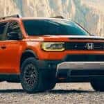 An orange 2026 Honda Passport TrailSport Elite is shown parked after viewing a Honda Passport for sale in Rochester.