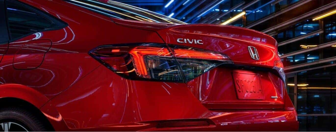 The rear end of a red 2025 Honda Civic Hybrid is shown.