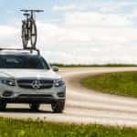 Silver Mercedes-Benz crossover SUV with bike mounted on roof