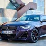 A purple 2024 BMW M240i xdrive is shown from the front at an angle after leaving a BMW dealer.