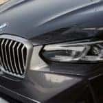 A close up shows the front end of a grey 2024 BMW X3 after visiting a BMW dealer.