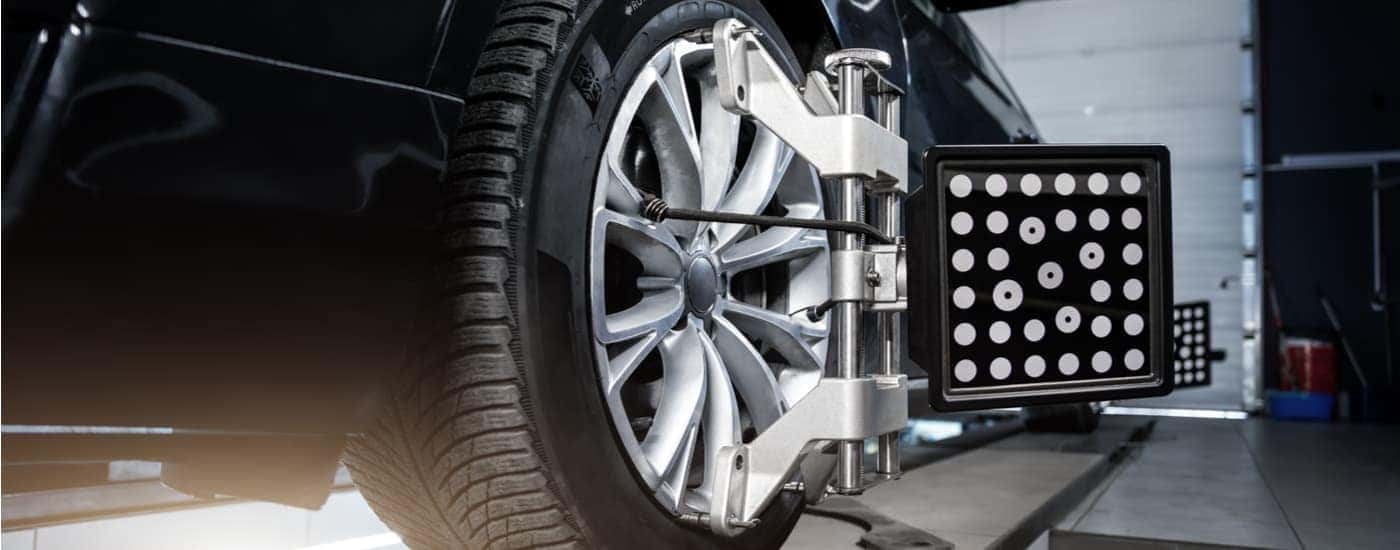 A black vehicle is getting an auto alignment done at a BMW service center.