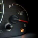 A low fuel light is shown on a dash.