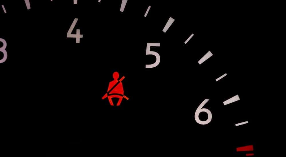 A seatbelt light is shown in a car at a BMW service center.