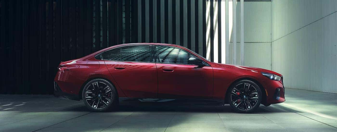 A side angle view of a red 2024 BMW i5 M60.
