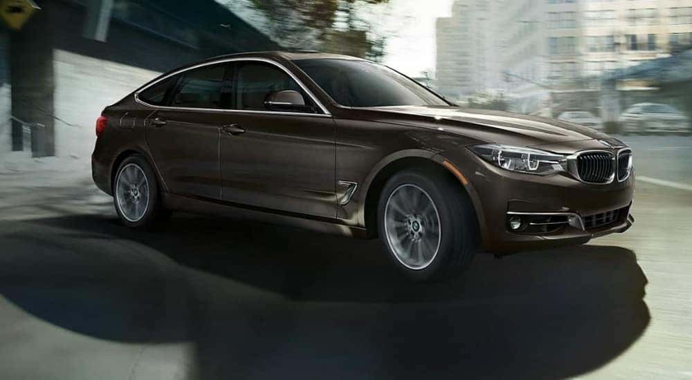 A brown 2019 BMW 3 Series Gran Turismo is shown driving to a used BMW dealer.