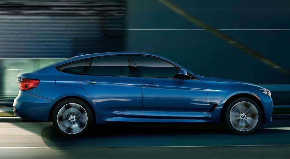 A blue 2019 BMW 3 Series Gran Turismo is shown driving in a tunnel.