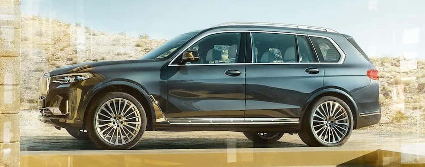 A gray 2020 BMW X7 is shown parked on a sunny day.