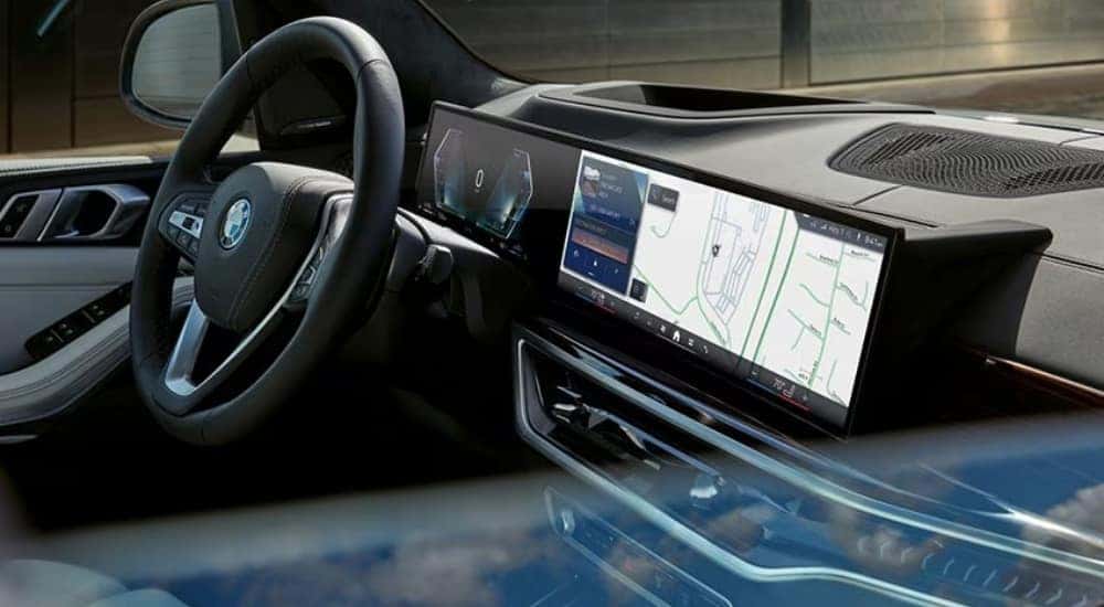 The infotainment screen and black interior is shown in a 2025 BMW X5.