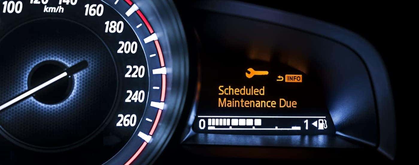 A schedule maintenance due alert is shown on a digital dash.