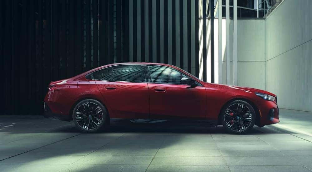 A red 2025 BMW i5 M60 is shown from the side.