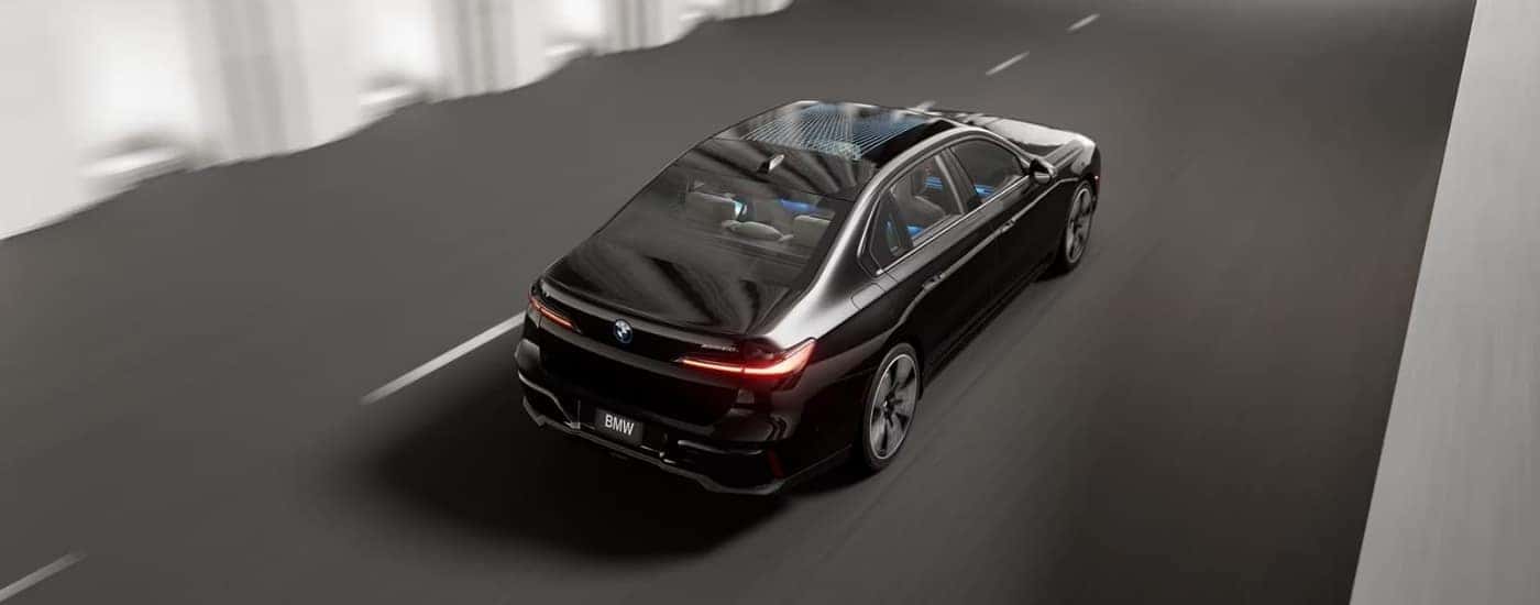 Black 2024 BMW i7 driving on a highway