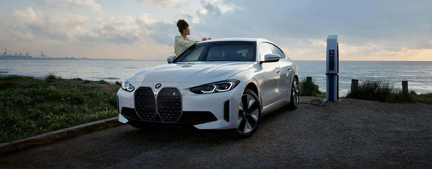 White 2024 BMW i4 Gran Coupe overlooking the ocean