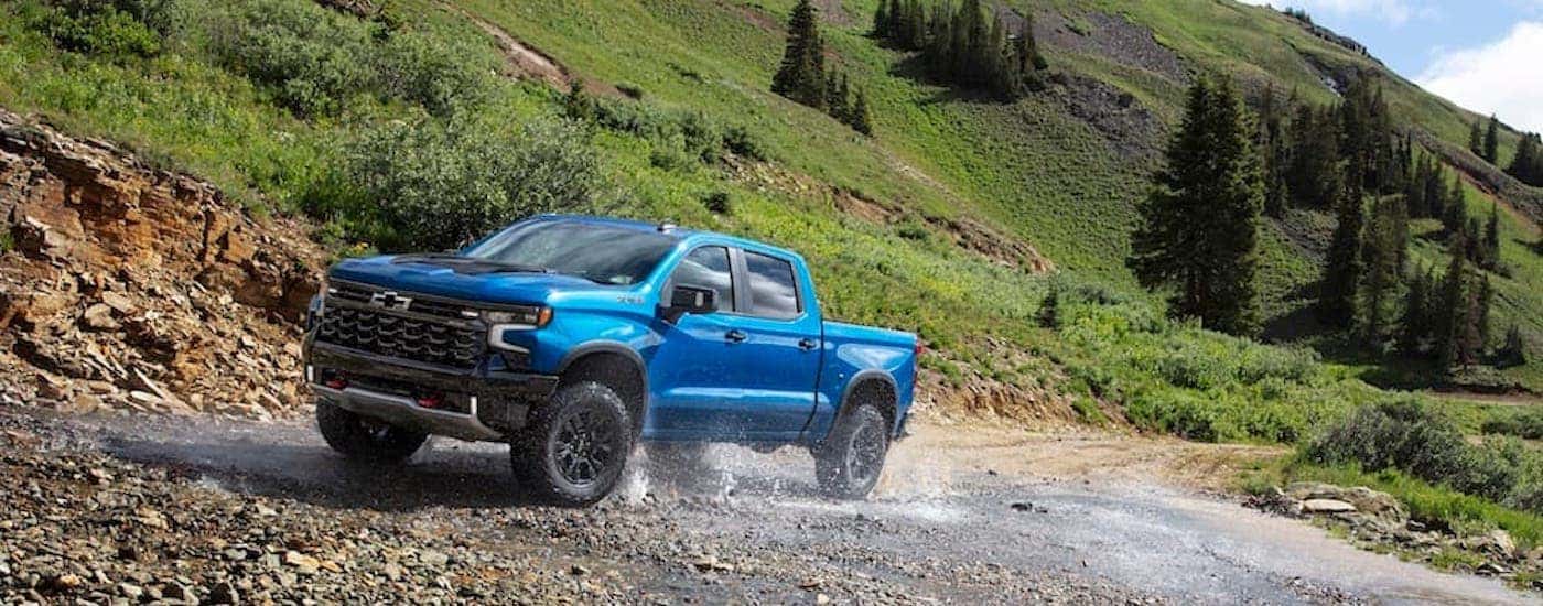 A blue 2024 Chevy Silverado 1500 ZR2 from the side.