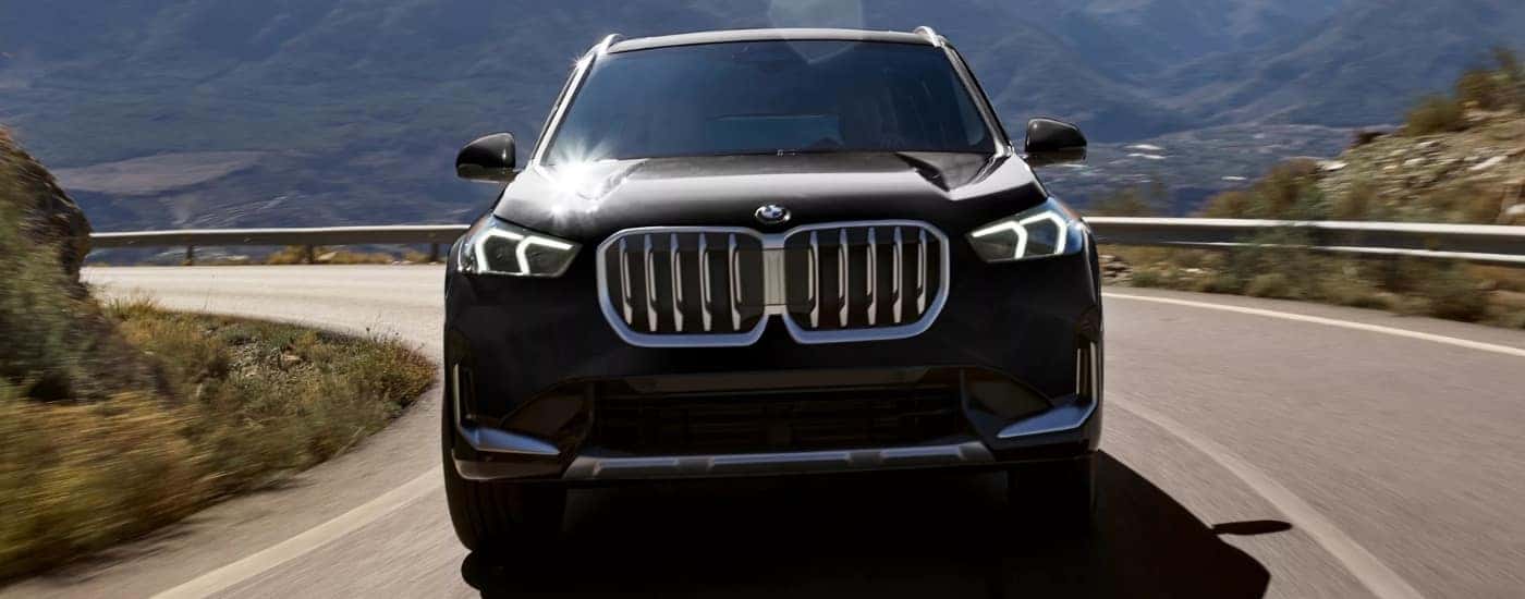 A black 2026 BMW X1 for sale rounding a corner.