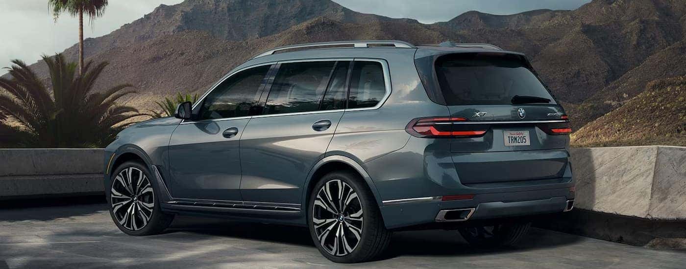A blue 2026 BMW X7 parked off-road