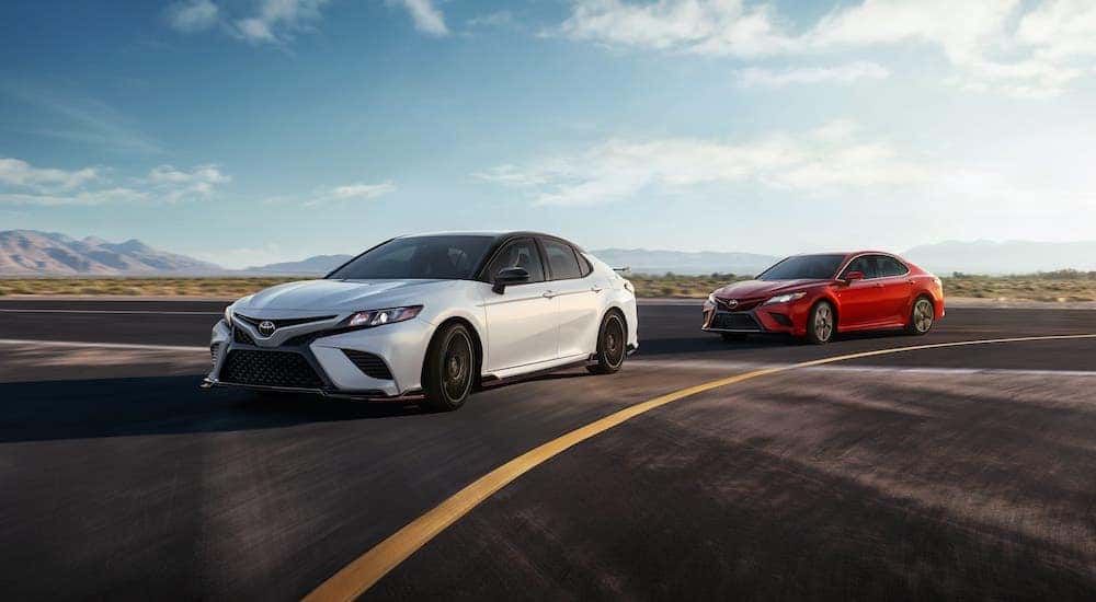 A white and a red 2020 Toyota Camry are driving on a track near Romeoville, IL.