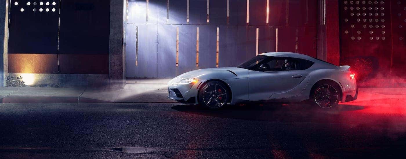 A white 2021 Toyota Supra is shown from the side at night.