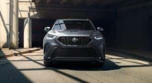 A gray 2021 Toyota Highlander is shown from the front while under a bridge.