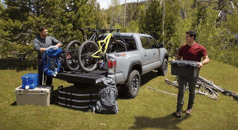 A silver 2021 Toyota Tacoma TRD is shown from behind with bikes in the bed after leaving a Toyota truck dealer.