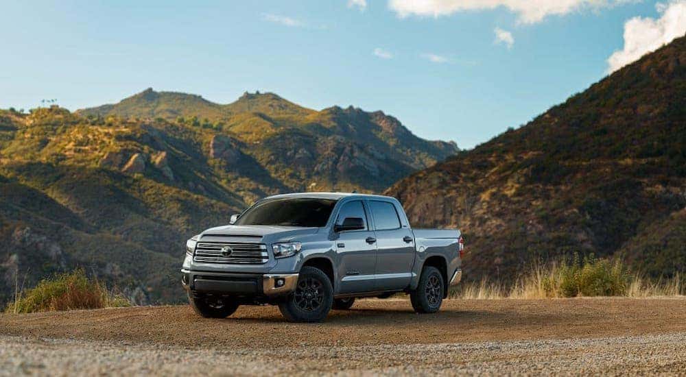 A silver 2021 Toyota Tundra is parked in front of mountains.