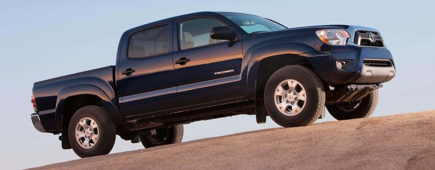 A dark blue 2015 Toyota Tacoma is shown parked after visiting a Toyota Tacoma dealer.