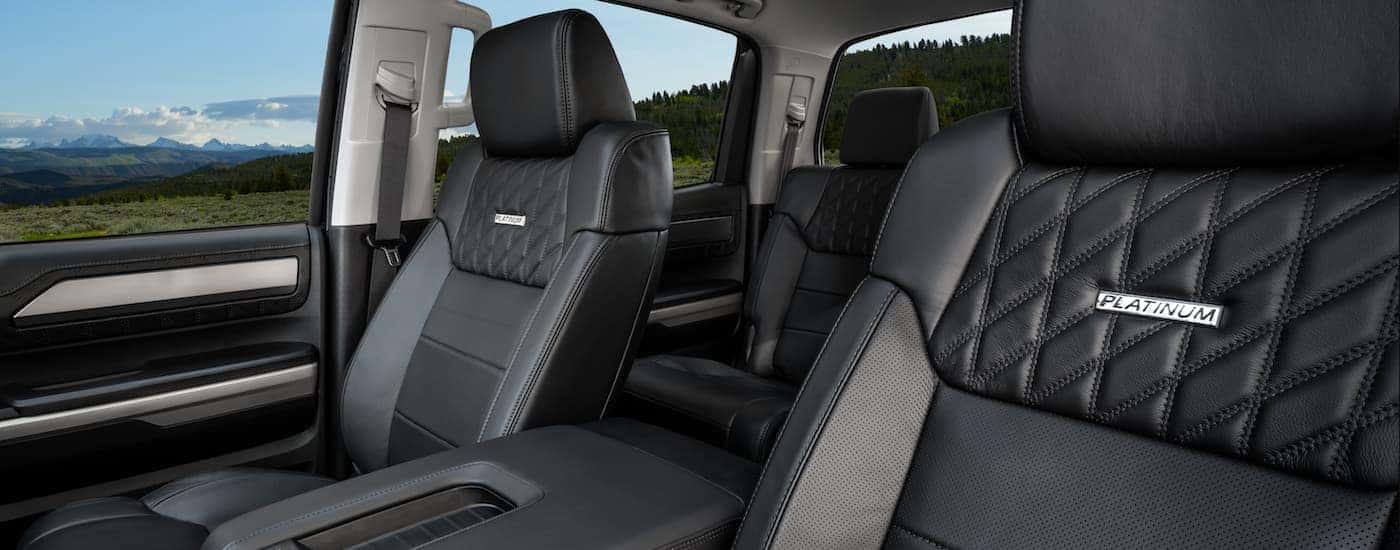 A black interior of a 2021 Toyota Tundra is shows two rows of seating.